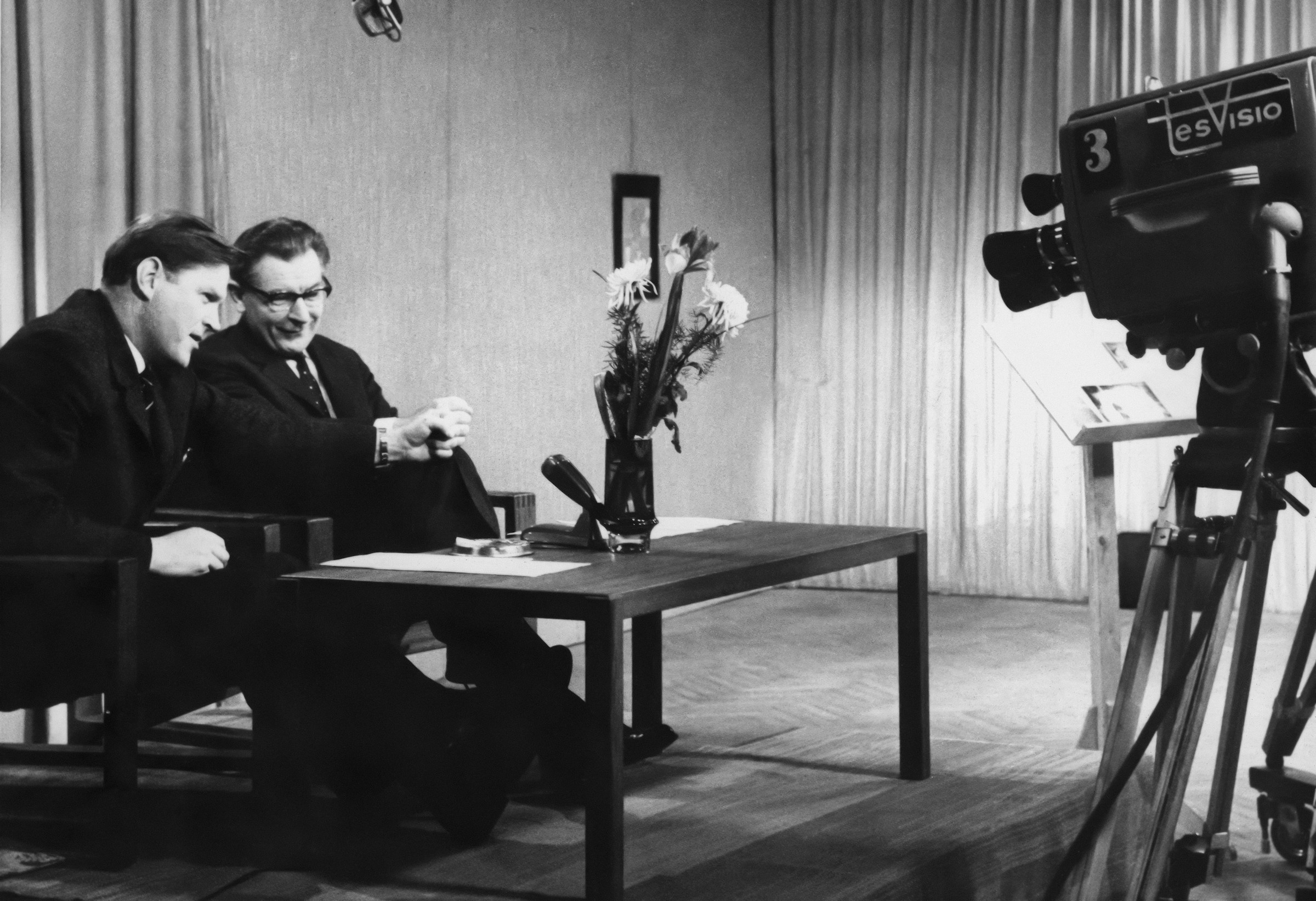 Two guys at a table, recoding setting with microphone and camera